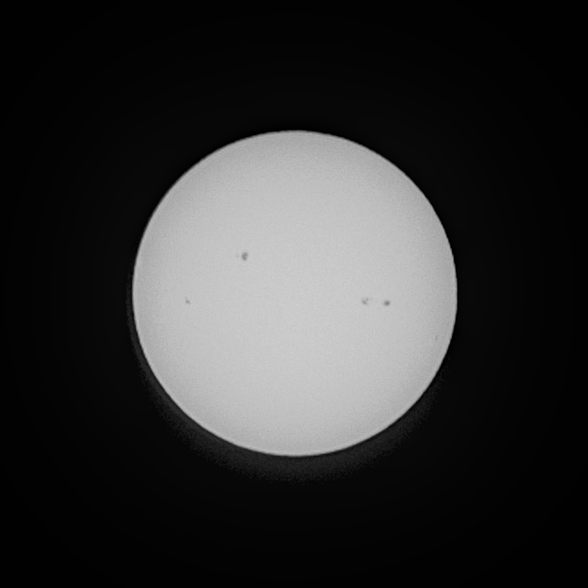 Full disc photo of the sun, showing four large sunspots.