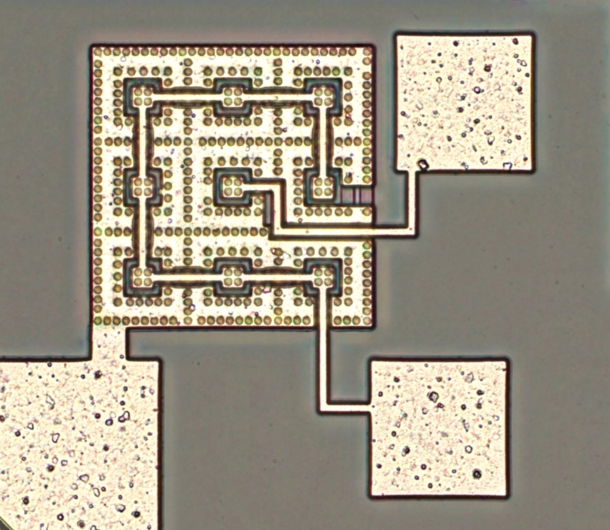 9 square features, where outer 8 are connected to one pad and the one in center is connected to another one.
