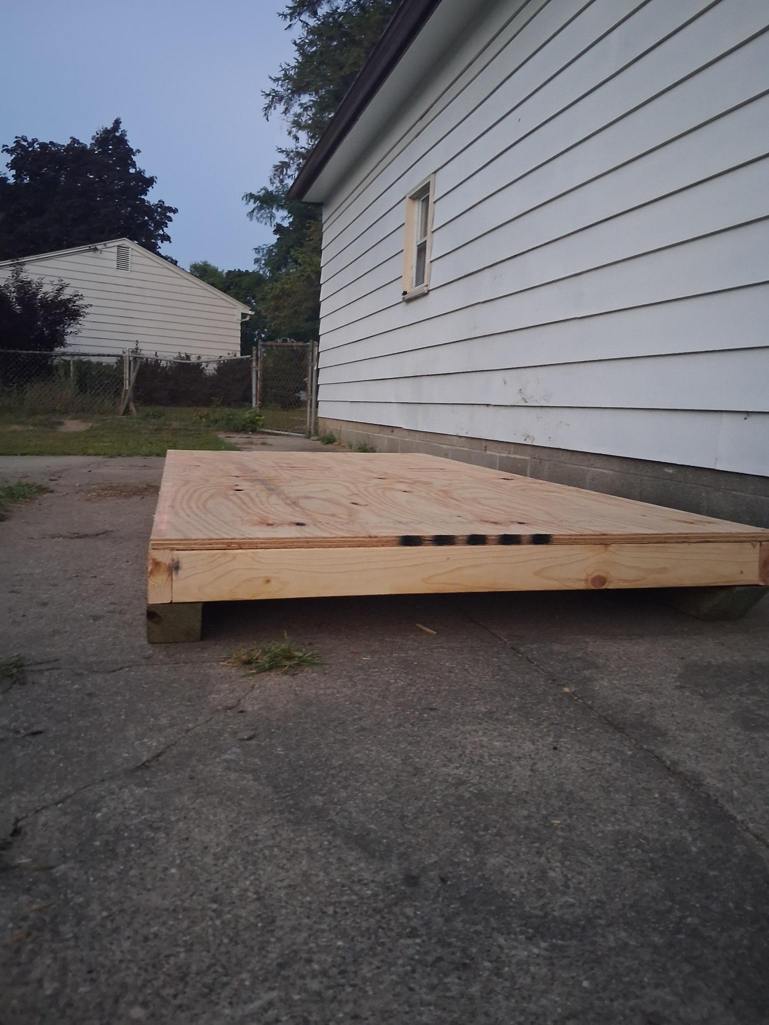 Framed 4x8 platform made of 2x4, and plywood, on top of 4x4 skids
