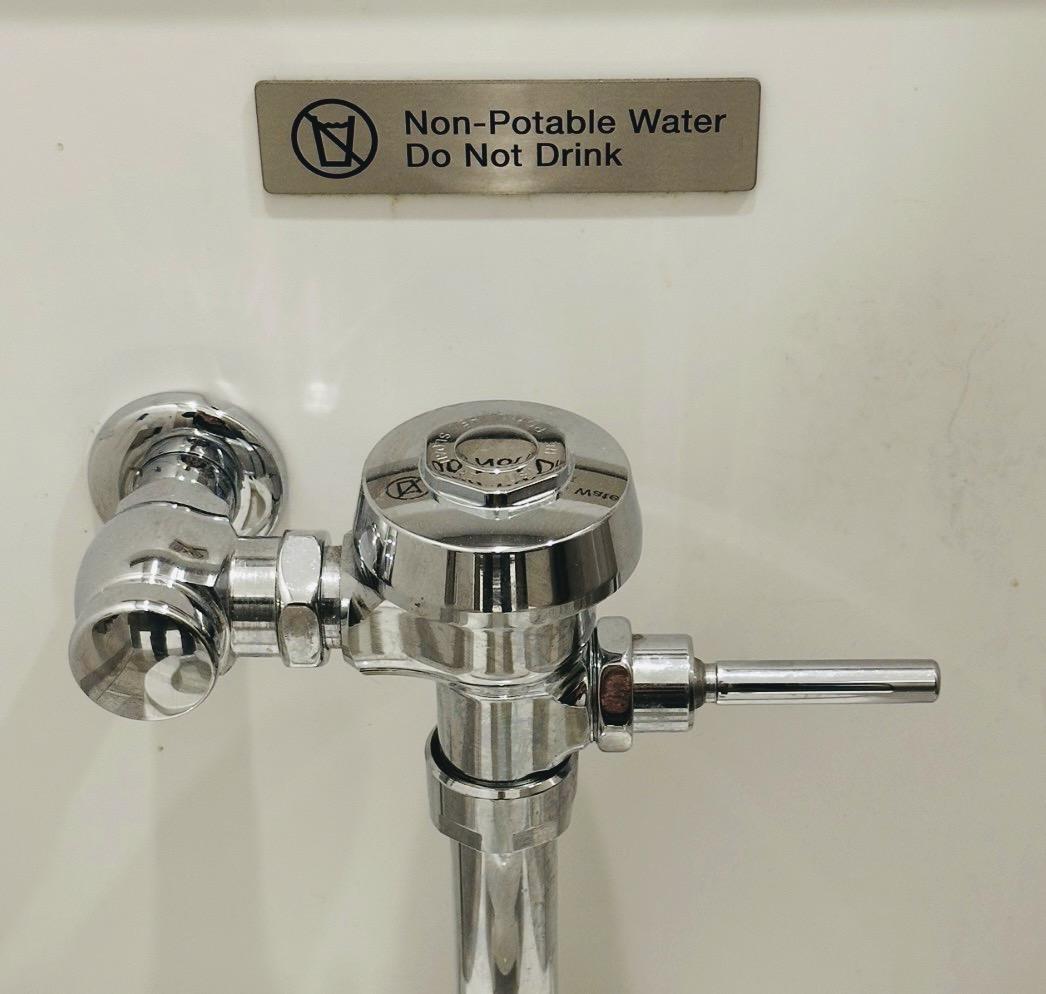 Sign on toilet wall says “ Non-Potable Water
Do Not Drink”