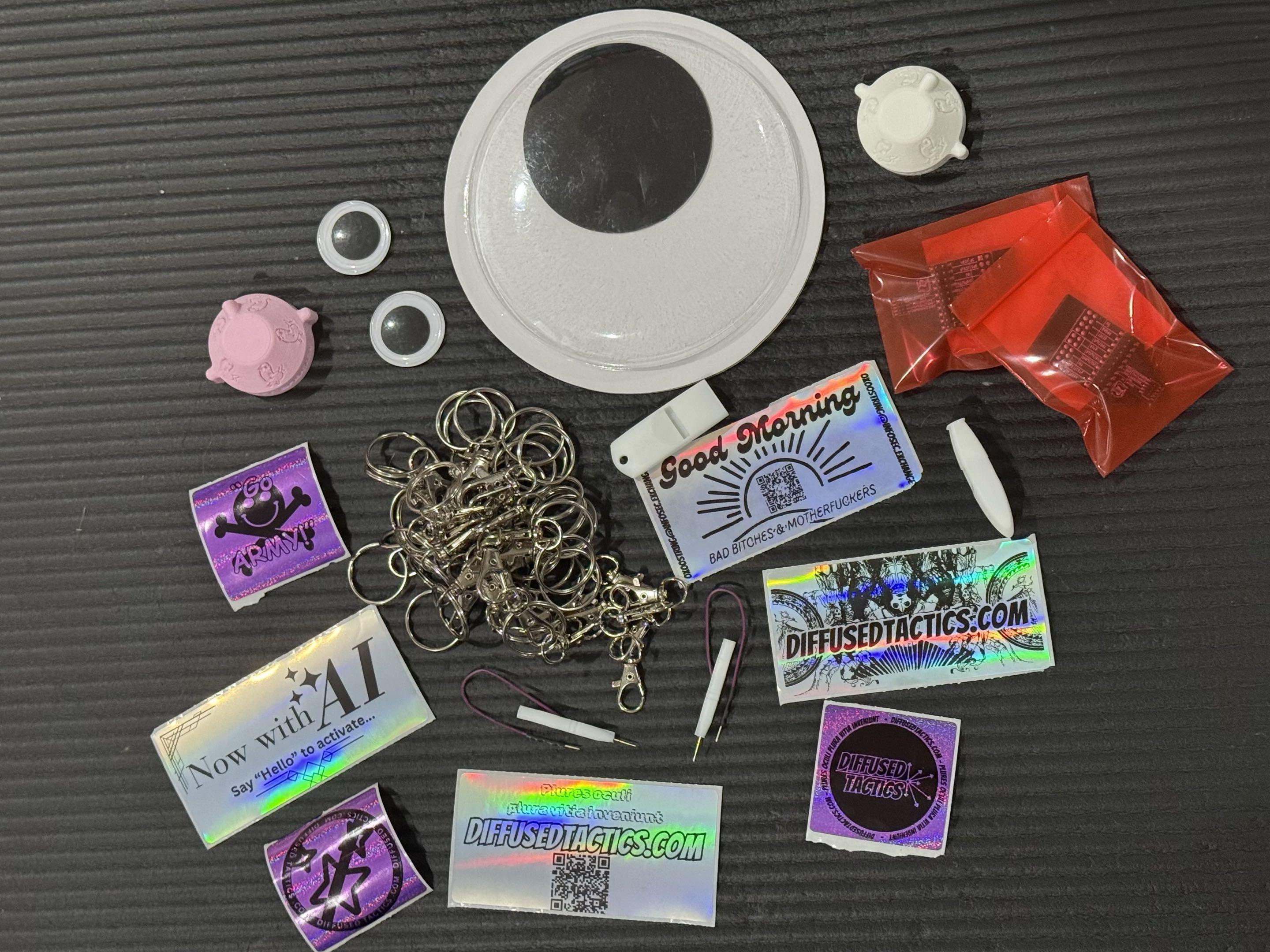 the following, all laying on the floor

googly eyes
large googly eyes
soda bottle bidet adapters
stickers
keyrings and lobster claws
universal fit low speed probes
2.54/1.27 jtag breakout adapters
novelty whistles
