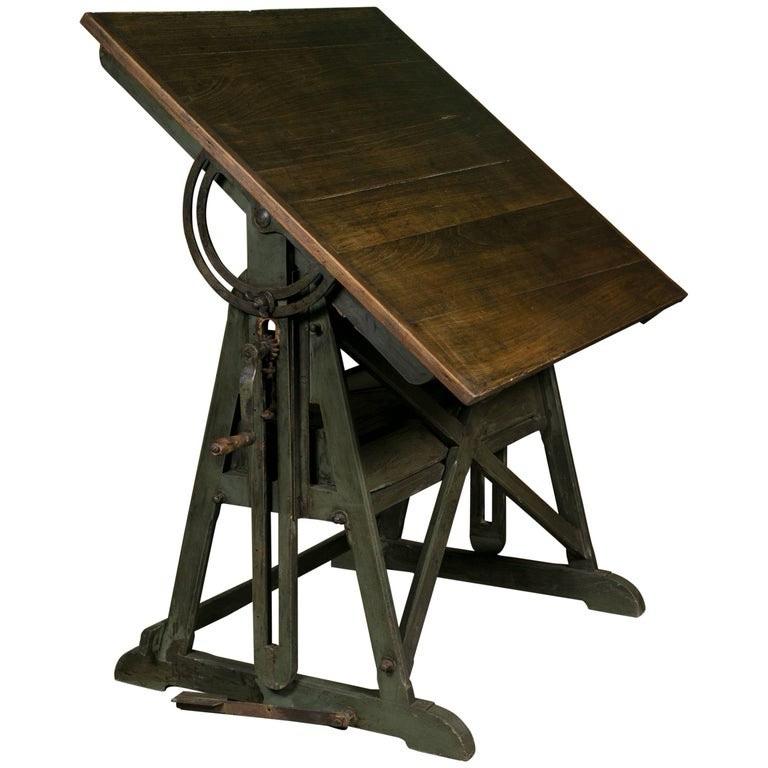 A wooden and metal architect's desk. It is tilted to allow an architect to draw on it. Because it is tilted, anything placed on it would slide off. Thus a desk with no clutter.