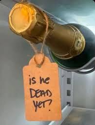 Bottle of wine with tag "is he dead yet?"