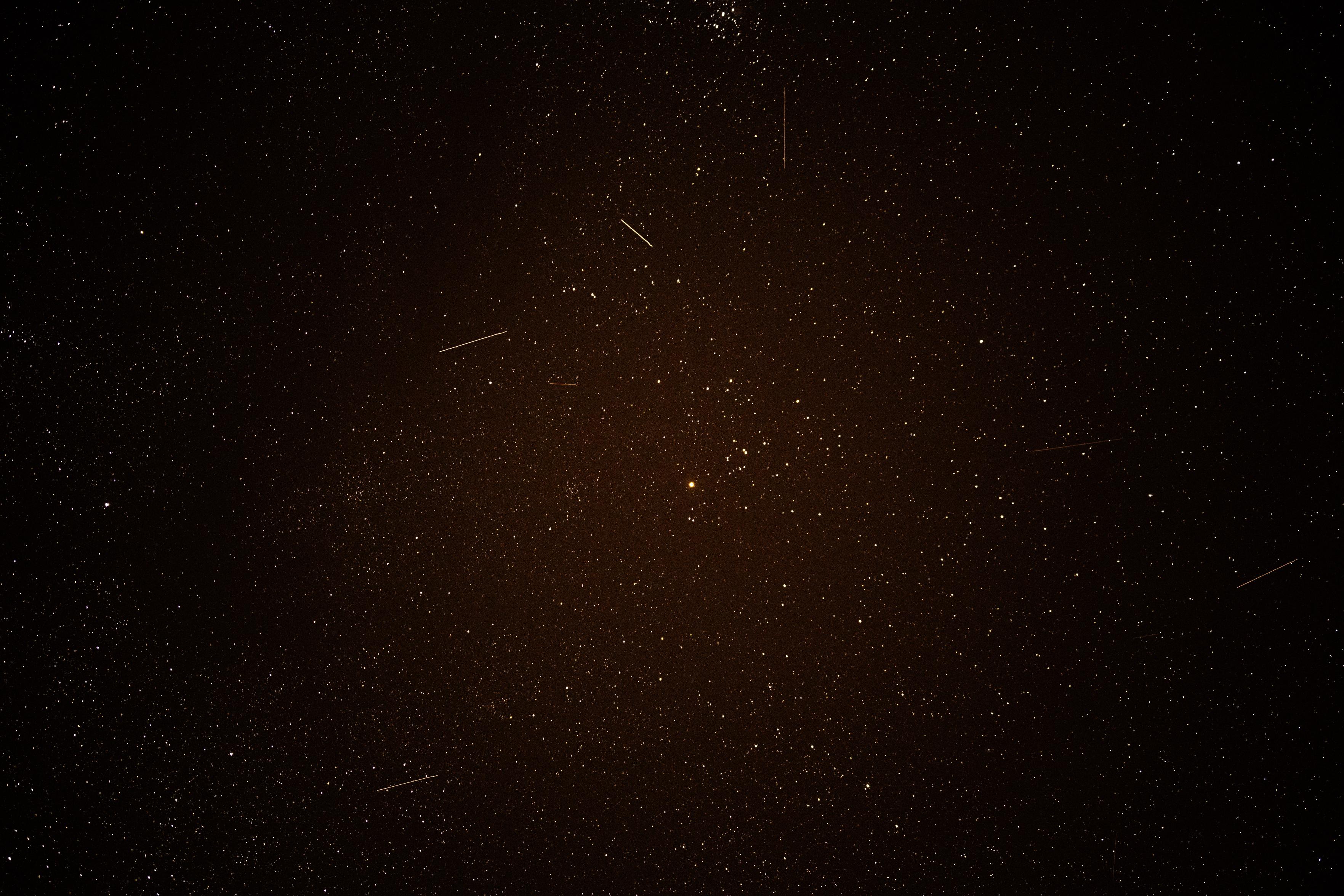 A night sky picture, showing lots of stars and 6 satellite tracks.