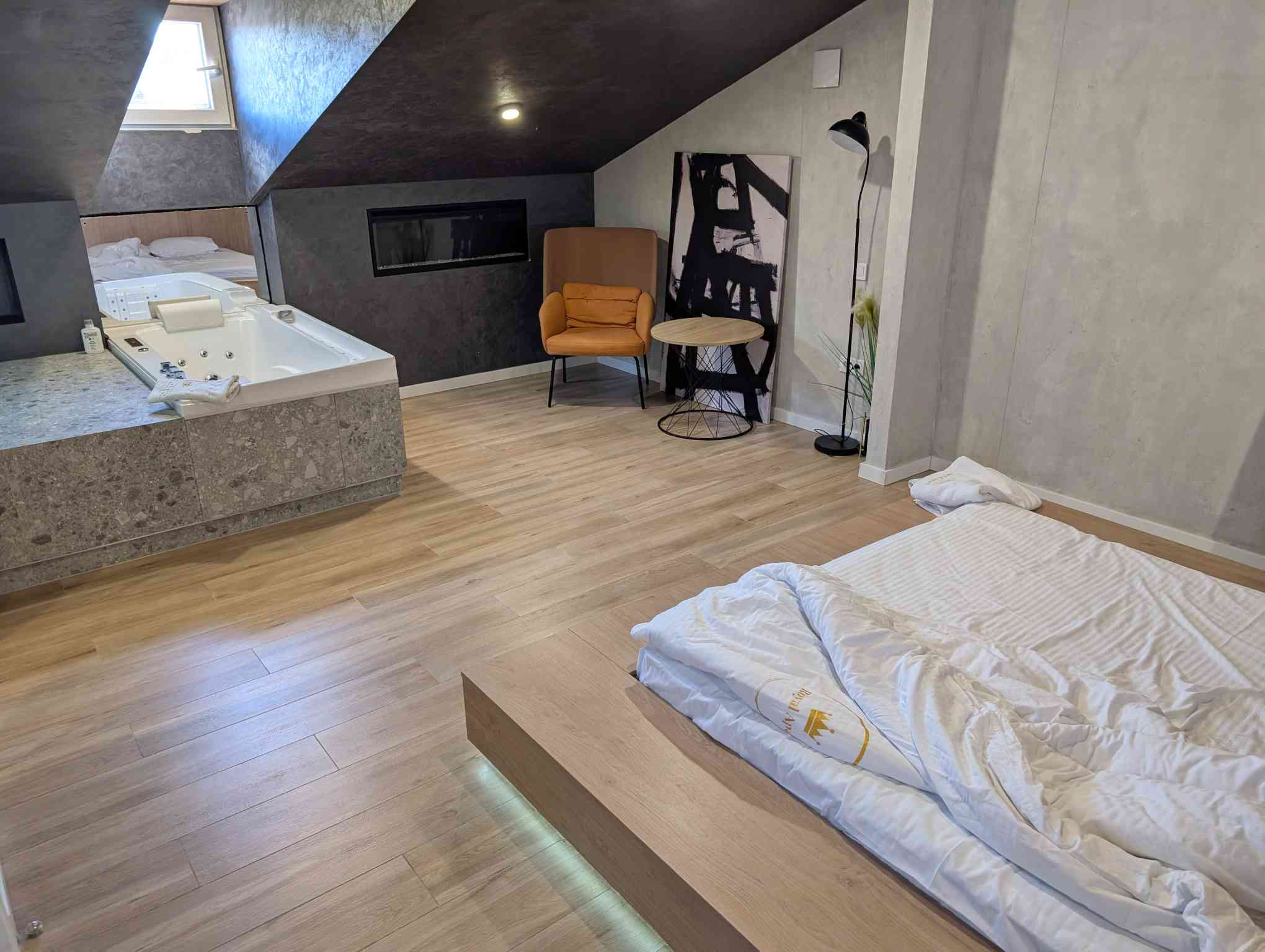 a hotel room, where a jacuzzi tub is positioned witha  perfect view of the bed.