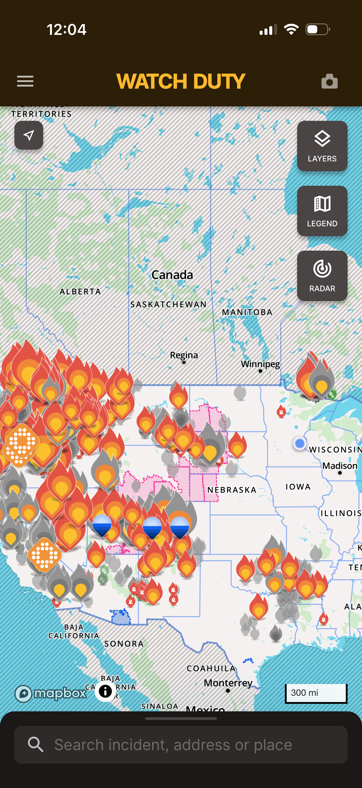 A screenshot of the fire tracking app watch duty showing the western quarter of the United States doused in forest fires