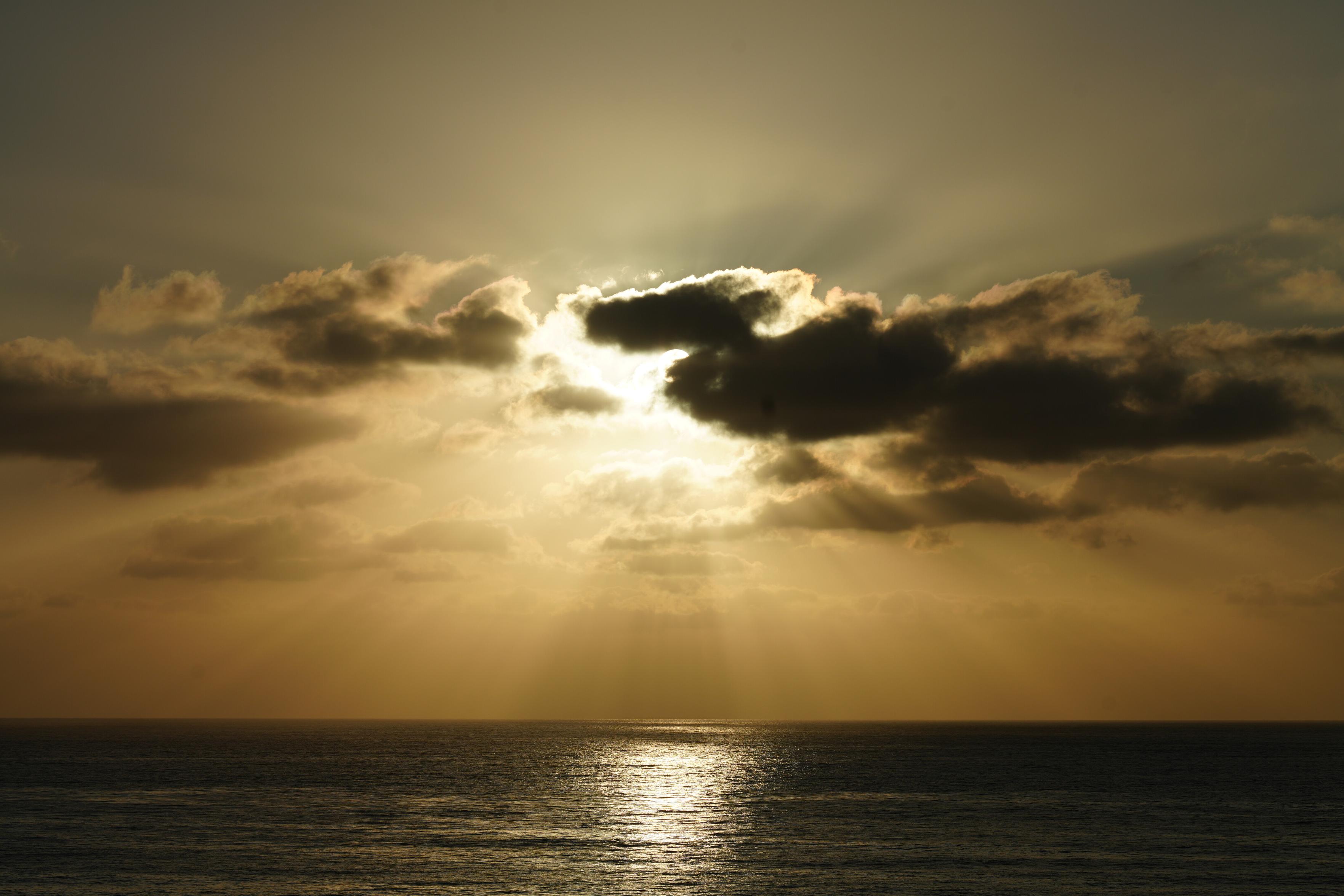 Photo of a sunset over a beach with a huge orange tint, shot with Minolta AF Macro 100mm lens