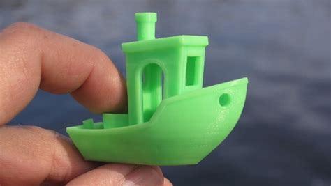 A picture of Benchy, a small 3D print of a boat, the standard object printed on a 3D Printer to assist in calibration and benchmarking. 