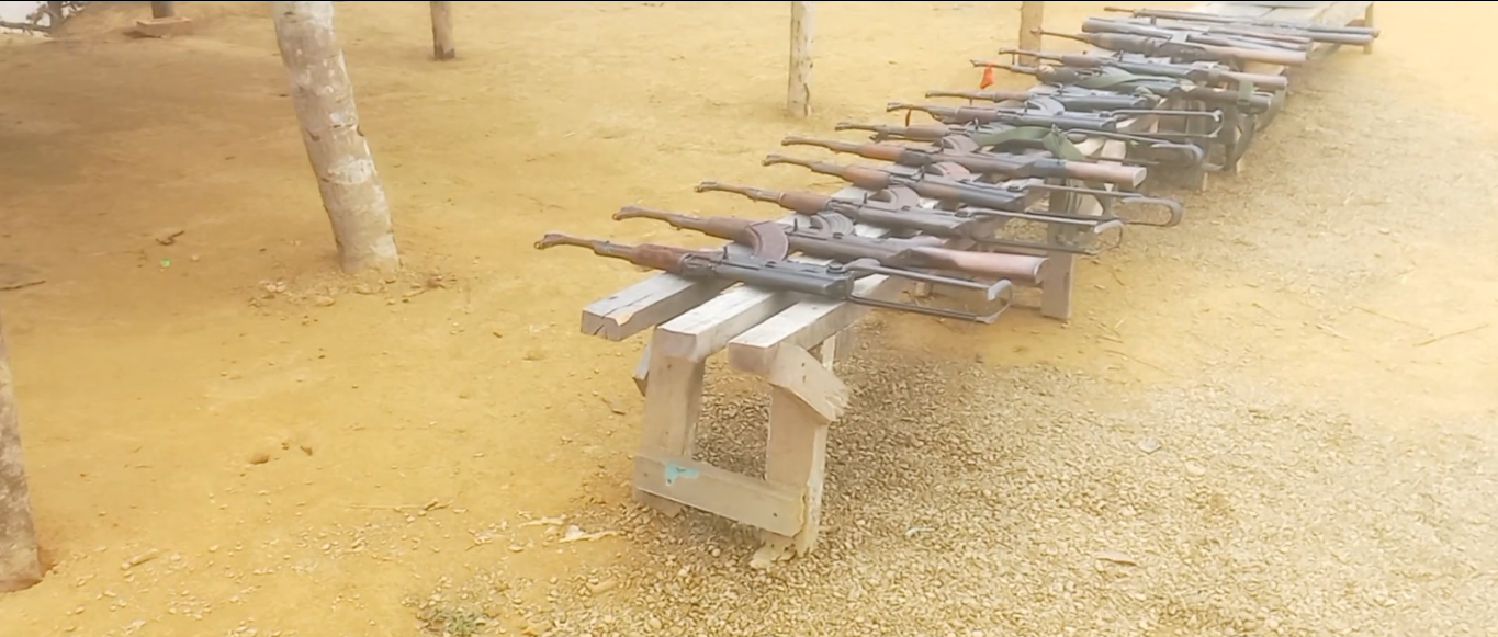 Numerous rifles on a rack being displayed at an insurgent camp.