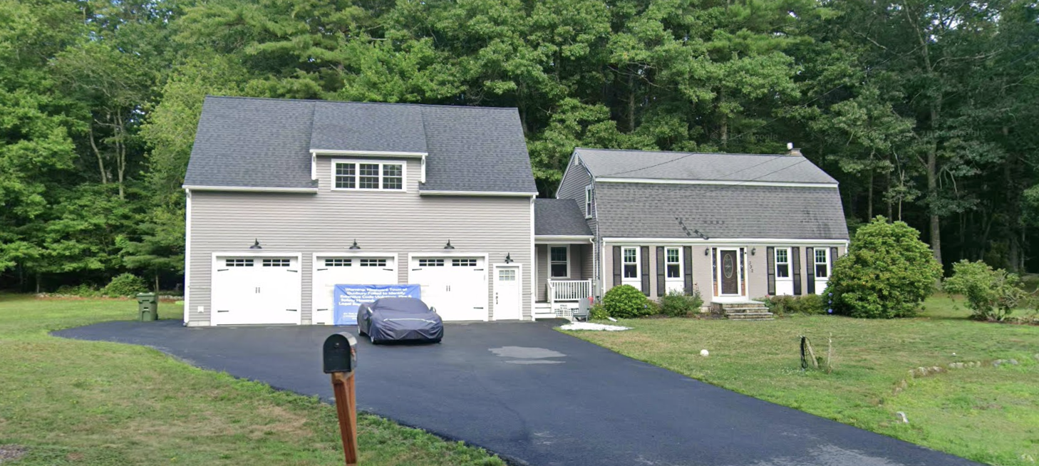 what used to be a nice, well-proportioned New England family home with a garden, now overshadowed by a three-door garage that is, I cannot emphasize this enough, bigger than the generously-sized family home in every dimension