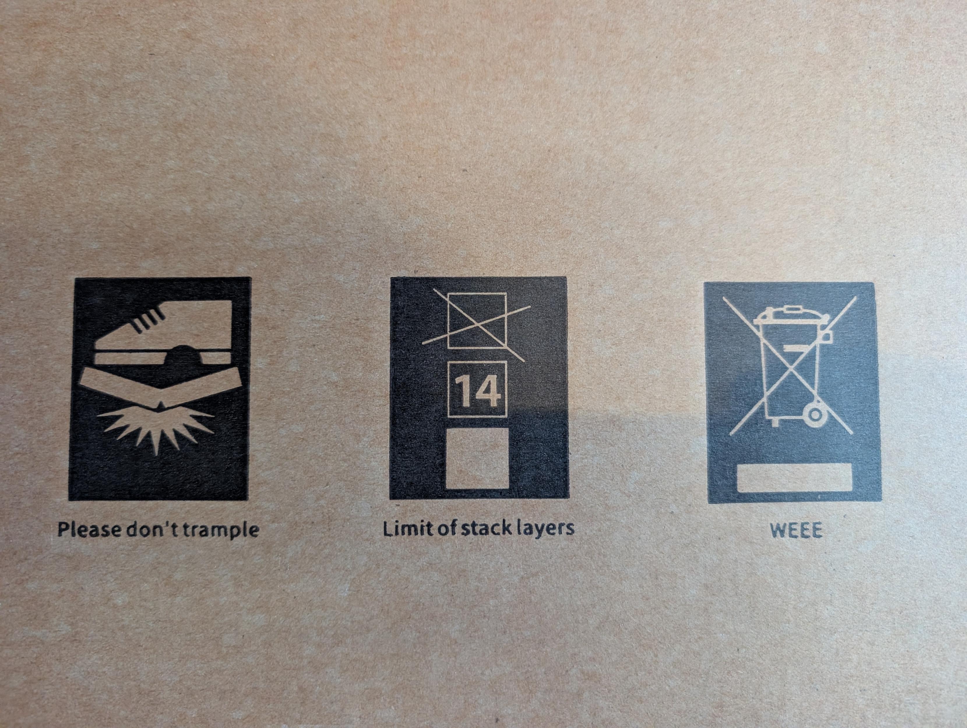 Three shipping symbols with unconventional labels. "do not step" is labeled "Please don't trample". "maximum stacking height" is labeled "Limit of stack layers". And, "do not dispose in bin" is labeled "WEEE".
