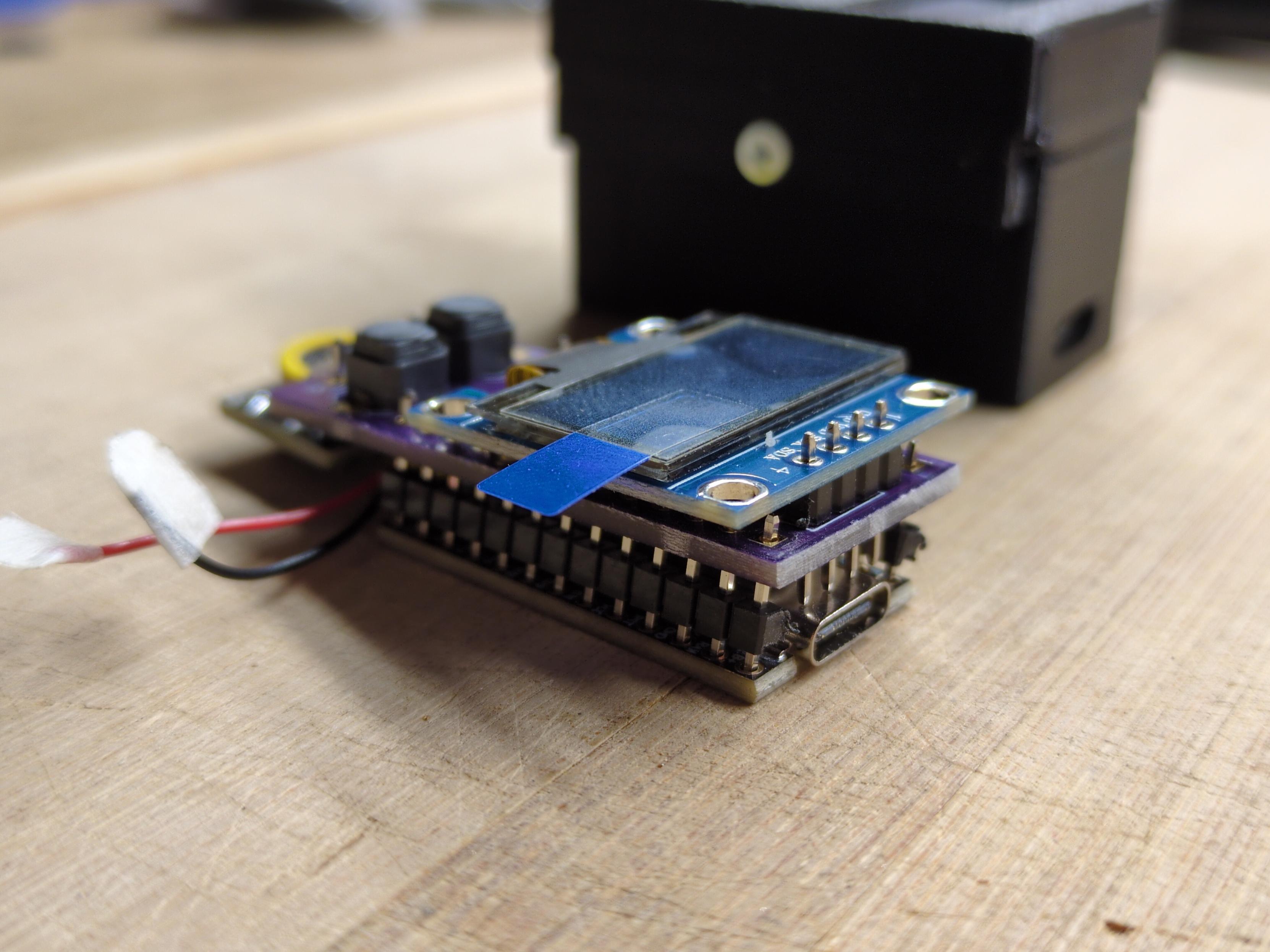 An alternative stacking arrangement puts the battery between the Nice!nano and the PCB. This makes the LCD pins less likely to short out, but introduces larger tolerances in how far apart the PCBs sit from one another.