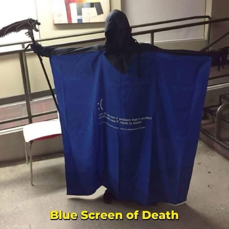 Person in a black leotard draped with a blue curtain that replicates the blue screen of death message from Windows.