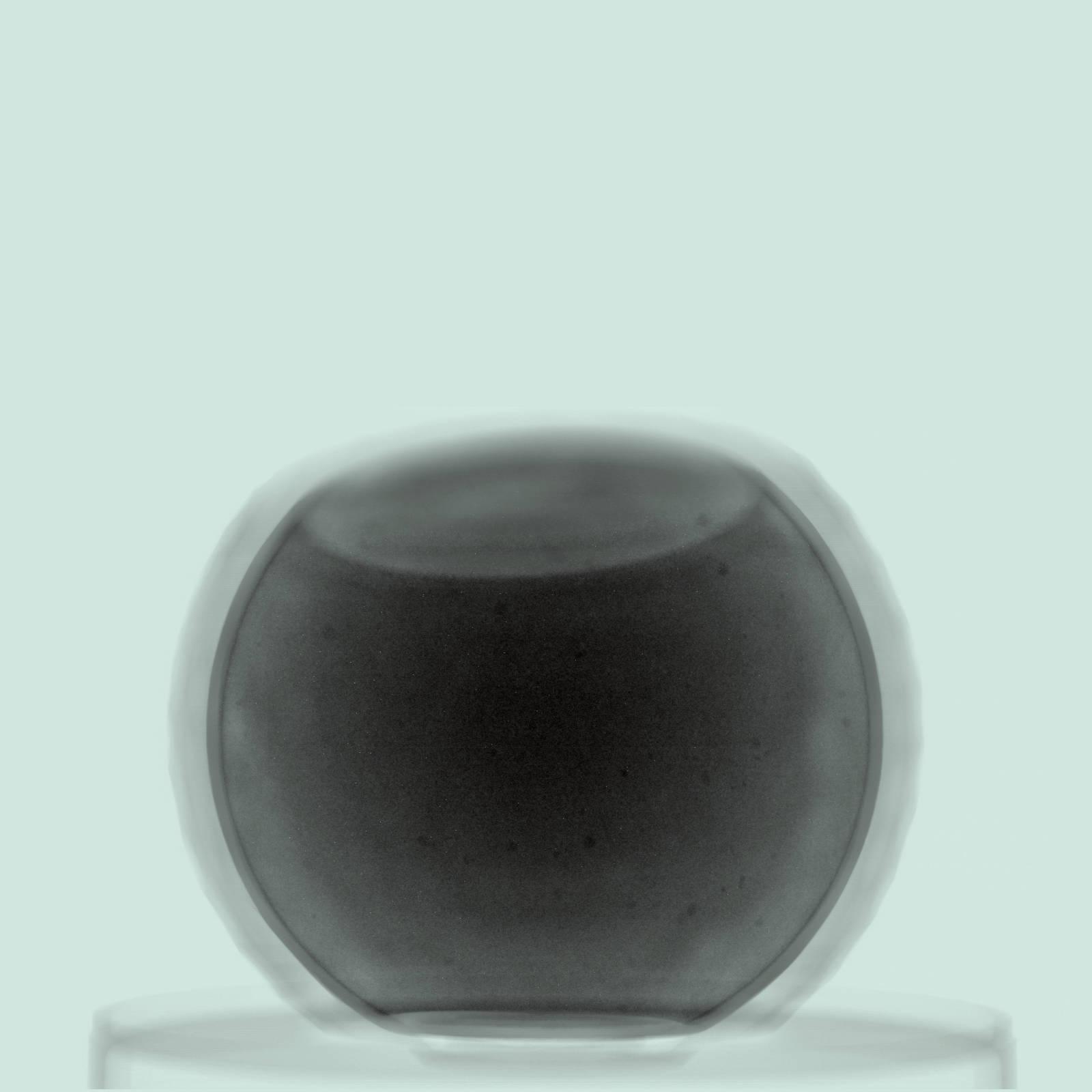 Colourised X-ray of a golf ball, but the top of the ball has been sliced off.